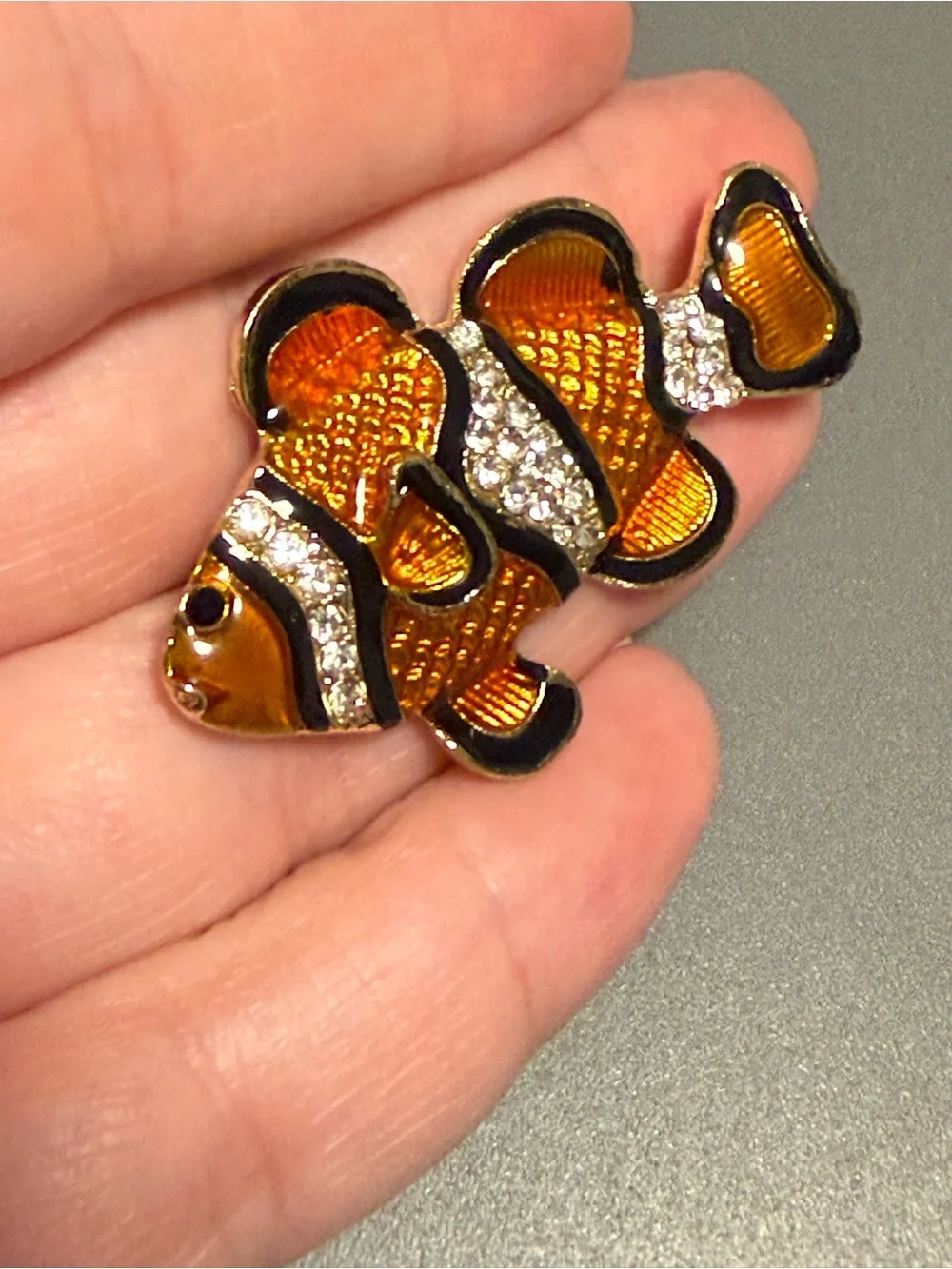 clownfish brooch featuring vibrant orange and black enamel